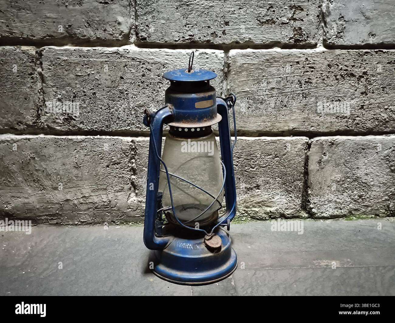 An old lantern with a brick wall background Stock Photo