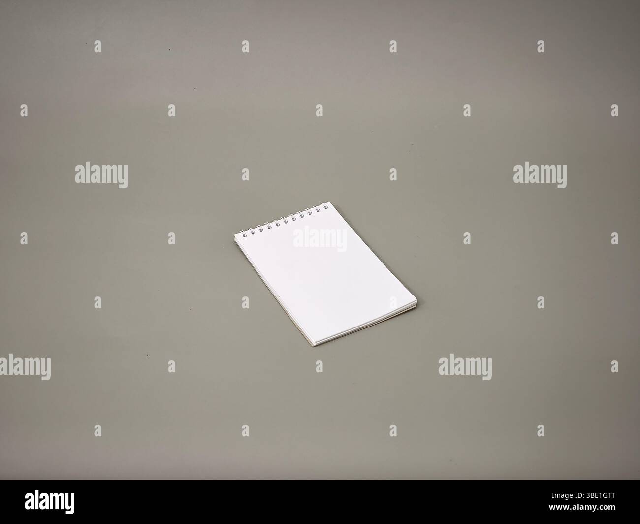 A small notebook over a grey background Stock Photo