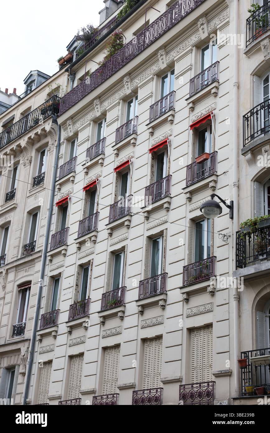 Classic Parisian Haussmann Building Facade with Balconies and Red ...