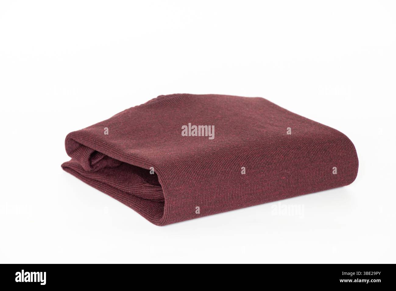 Folded burgundy men's turtleneck sweater on a white background, clothing for a catalog or online store Stock Photo