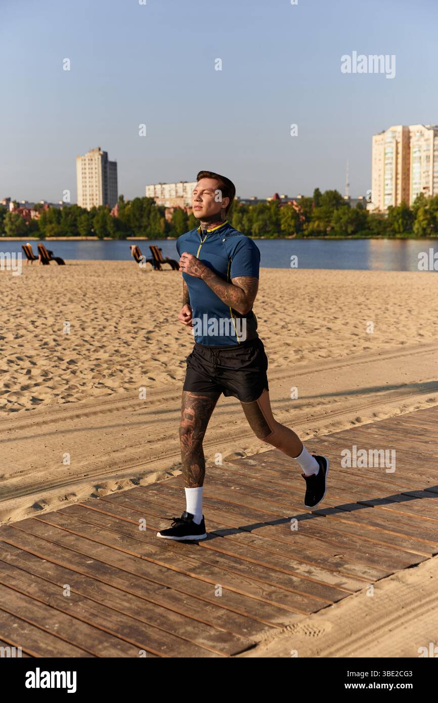 Handsome young man jogs along a sandy path by the water, soaking in the ...