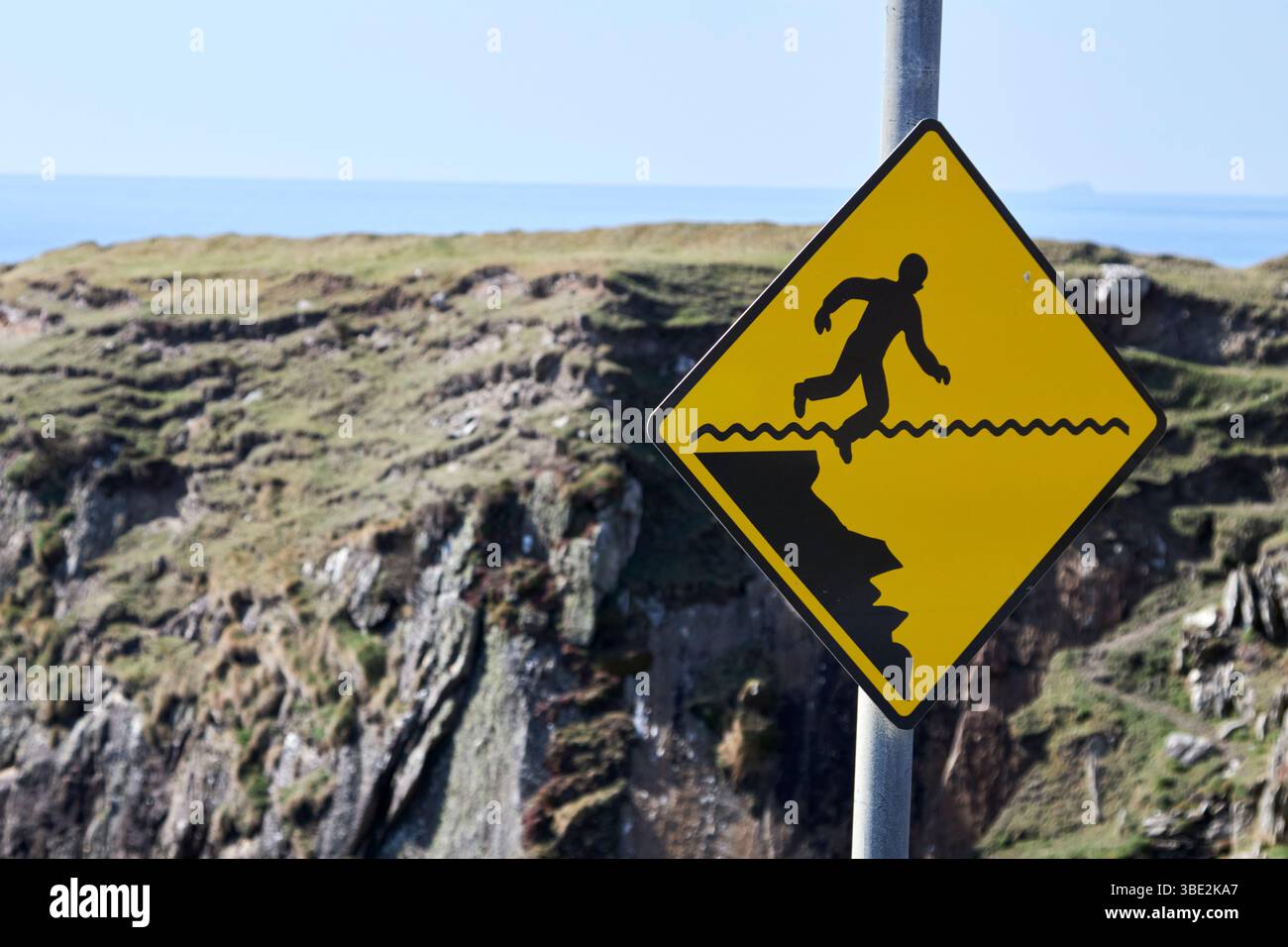 dangerous cliffs warning sign on rocky atlantic shoreline at claggan achill island county mayo republic of ireland Stock Photo
