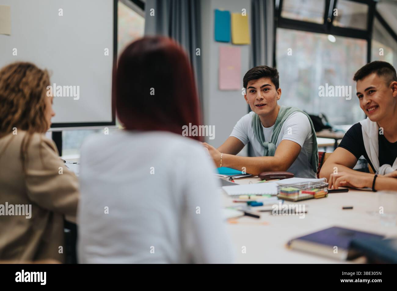 Students engaged in a collaborative classroom discussion Stock Photo
