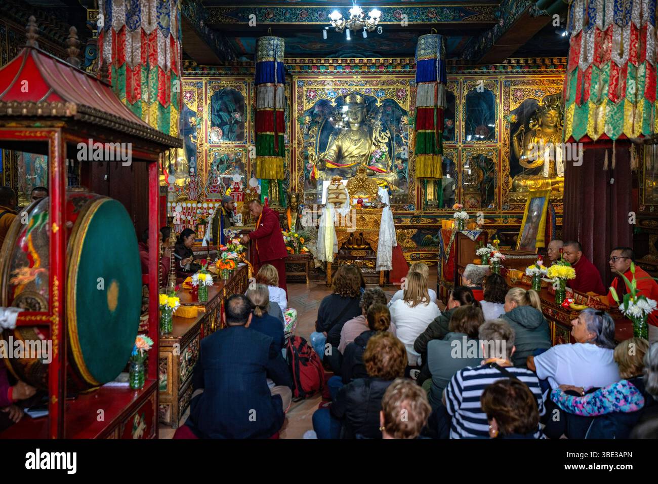 Nepal, Kathmandu, Boudhanath buddhist temple, europeans praying Stock Photo