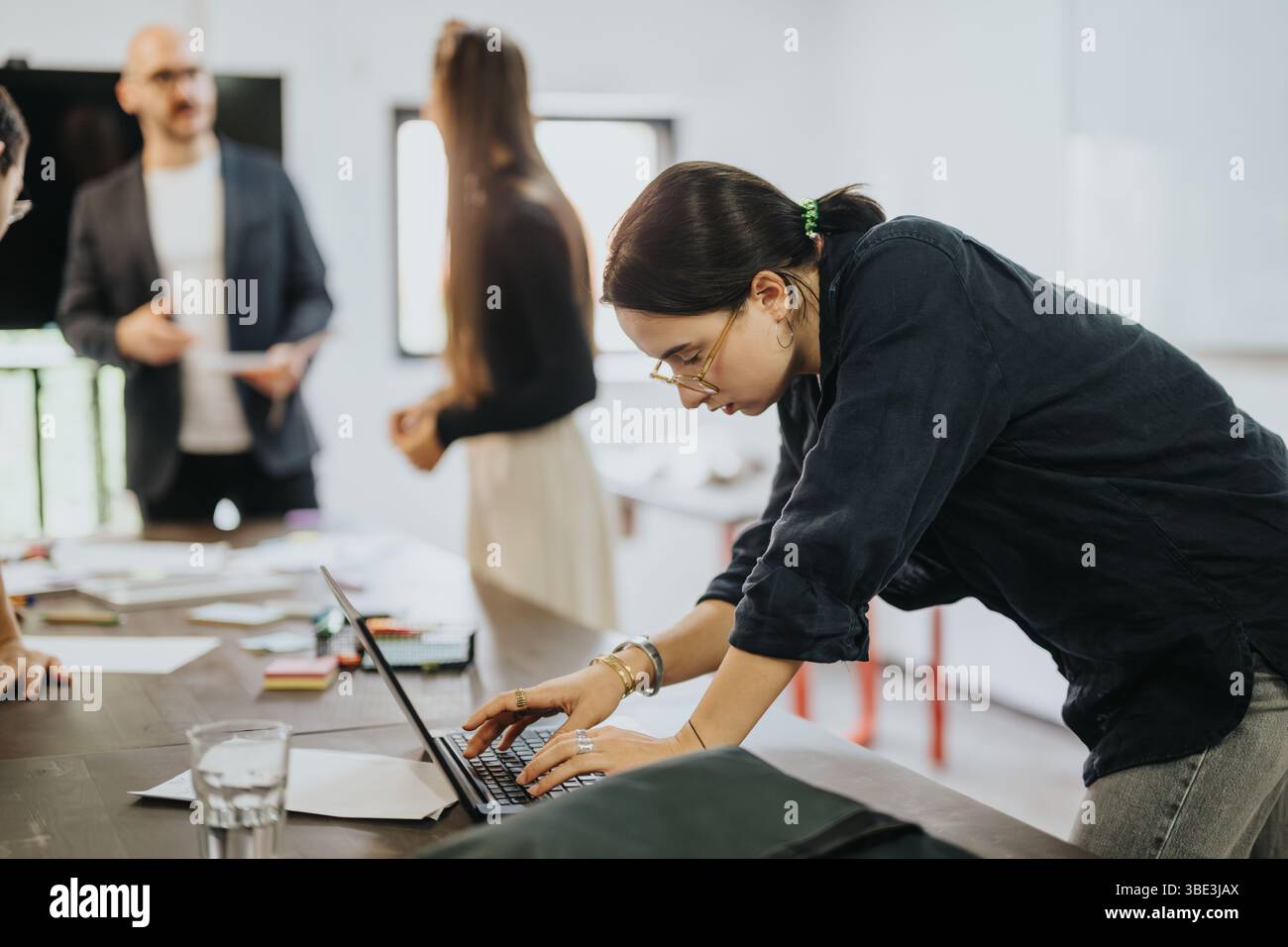 Students collaborating on a project with their supportive professor Stock Photo