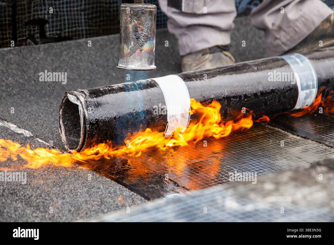 Roofer during waterproofing work with bitumen membranes Stock Photo - Alamy