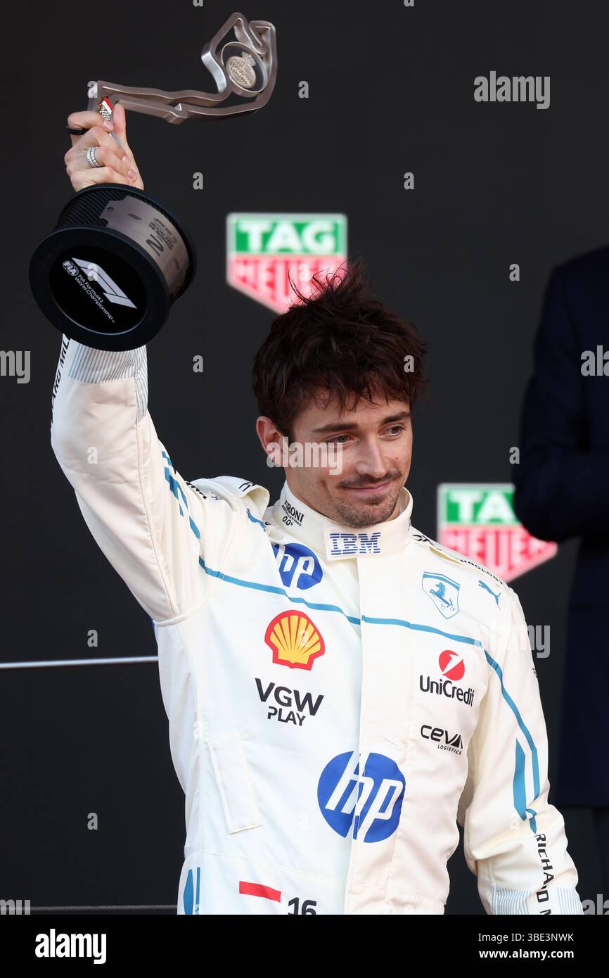 Charles Leclerc of Scuderia Ferrari celebrates on the podium during the ...
