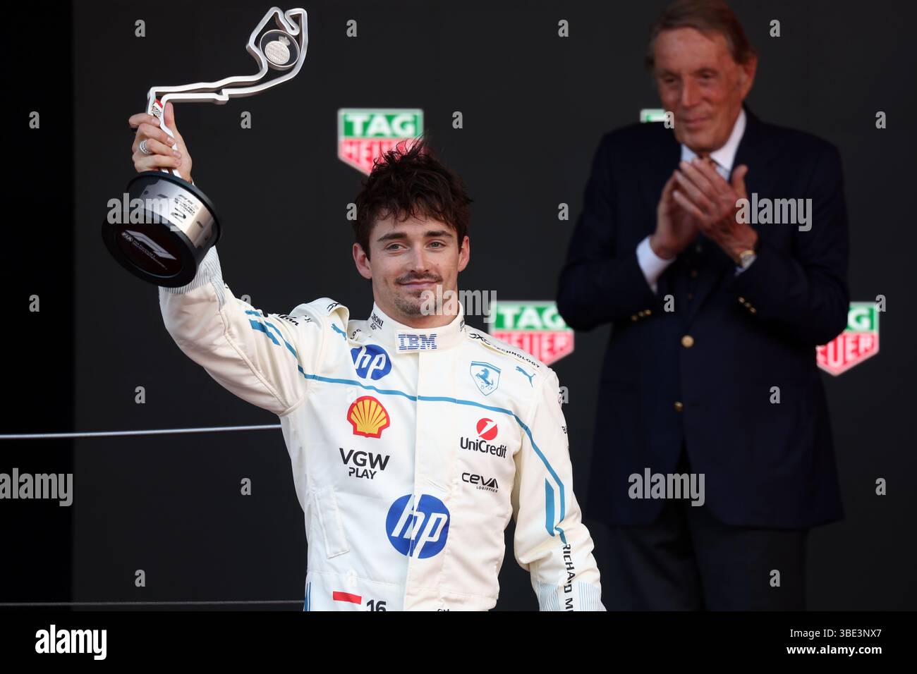Charles Leclerc of Scuderia Ferrari celebrates on the podium during the ...