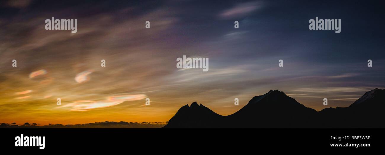 Polar stratospheric clouds glowing over Brunnhorn mountain, East Iceland. Stock Photo