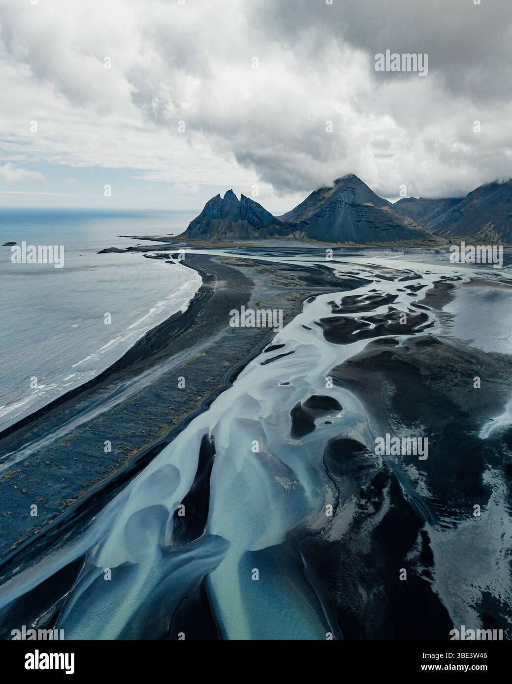 Dramatic aerial view of Brunnhorn mountain and braided river delta, Iceland. Stock Photo