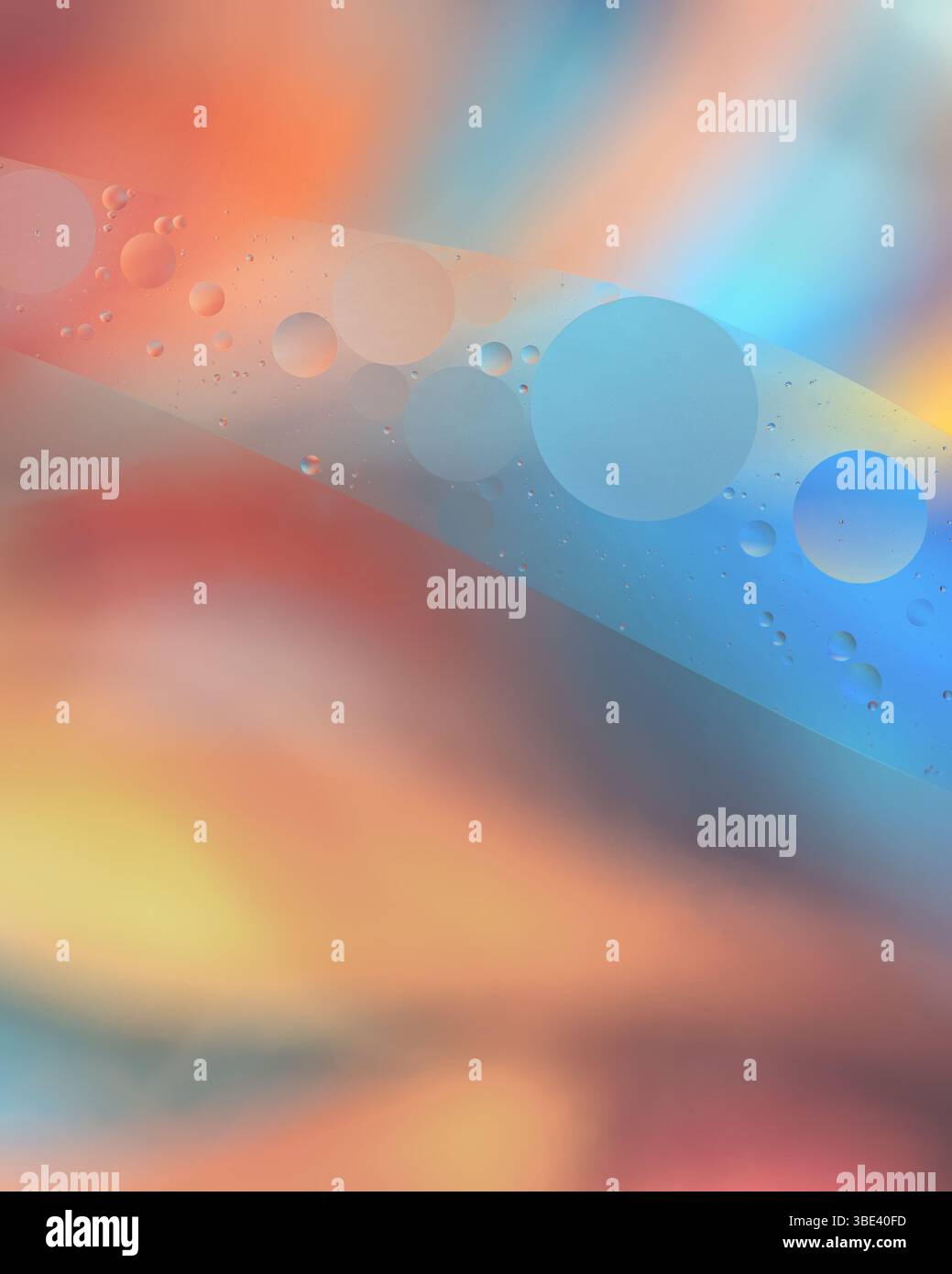 Bubbles of oil floating on water with a colourful astract background - Stock Image