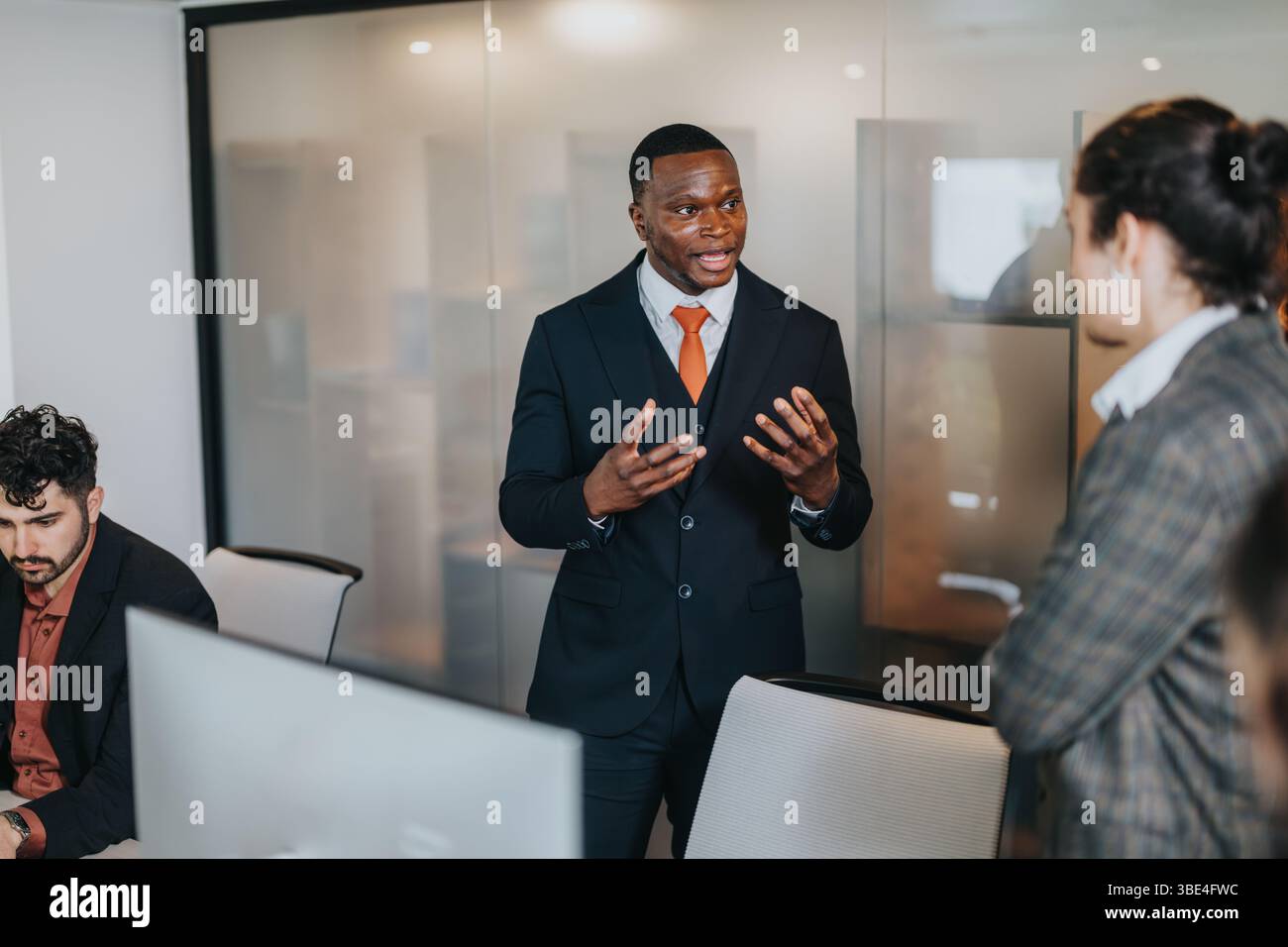 Colleagues Collaborating in a Modern Office Setting on Business Projects Stock Photo