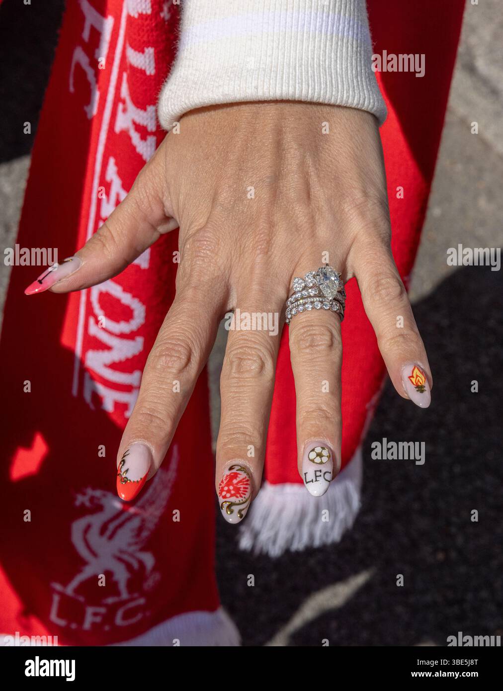 Liverpool FC soccer-themed nail art featuring the team's colors. Stock Photo