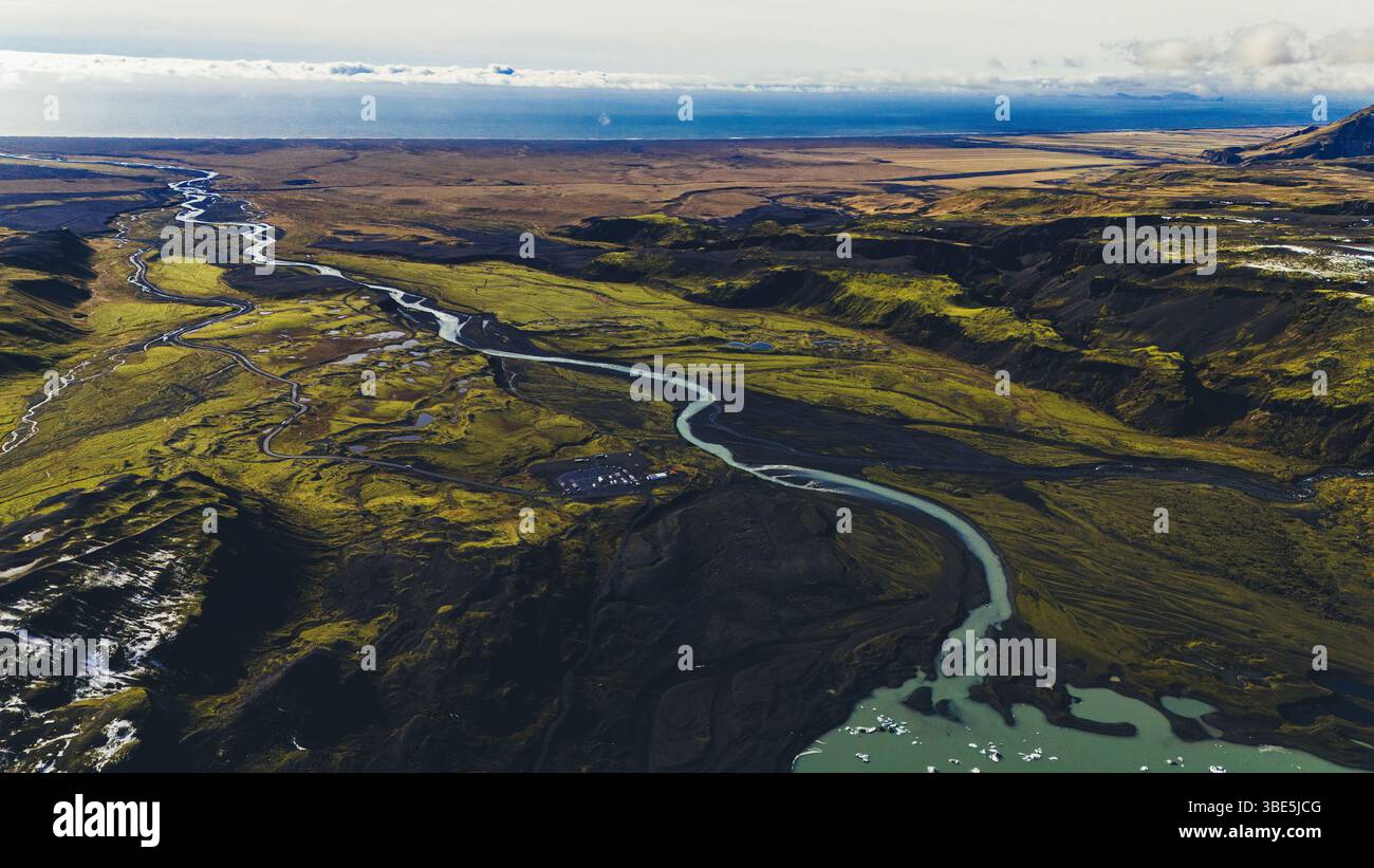 Wide aerial view of braided rivers flowing through mossy and volcanic ...