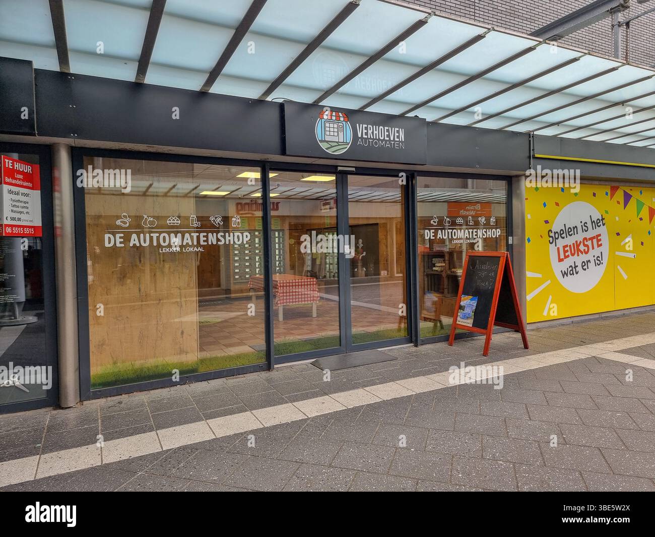 Facade of unmanned shop with only vending machines 'De Aurtomatenshop', selling fresh local food, dairy, meat, eggs, jams, etc; Eindhoven, Netherlands - Smartphone Captured Stock Image