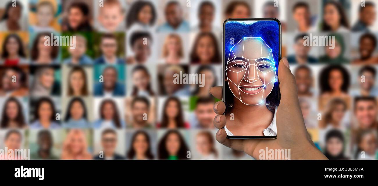A hand holds a smartphone displaying a digital face scan Stock Photo