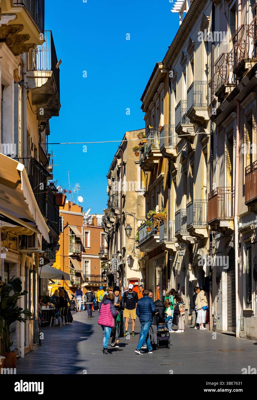 Taormina, Sicily, Italy - February 15, 2023: Historic old town quarter with traditional houses at Corso Umberto I main street of Taormina in Messina r Stock Photo