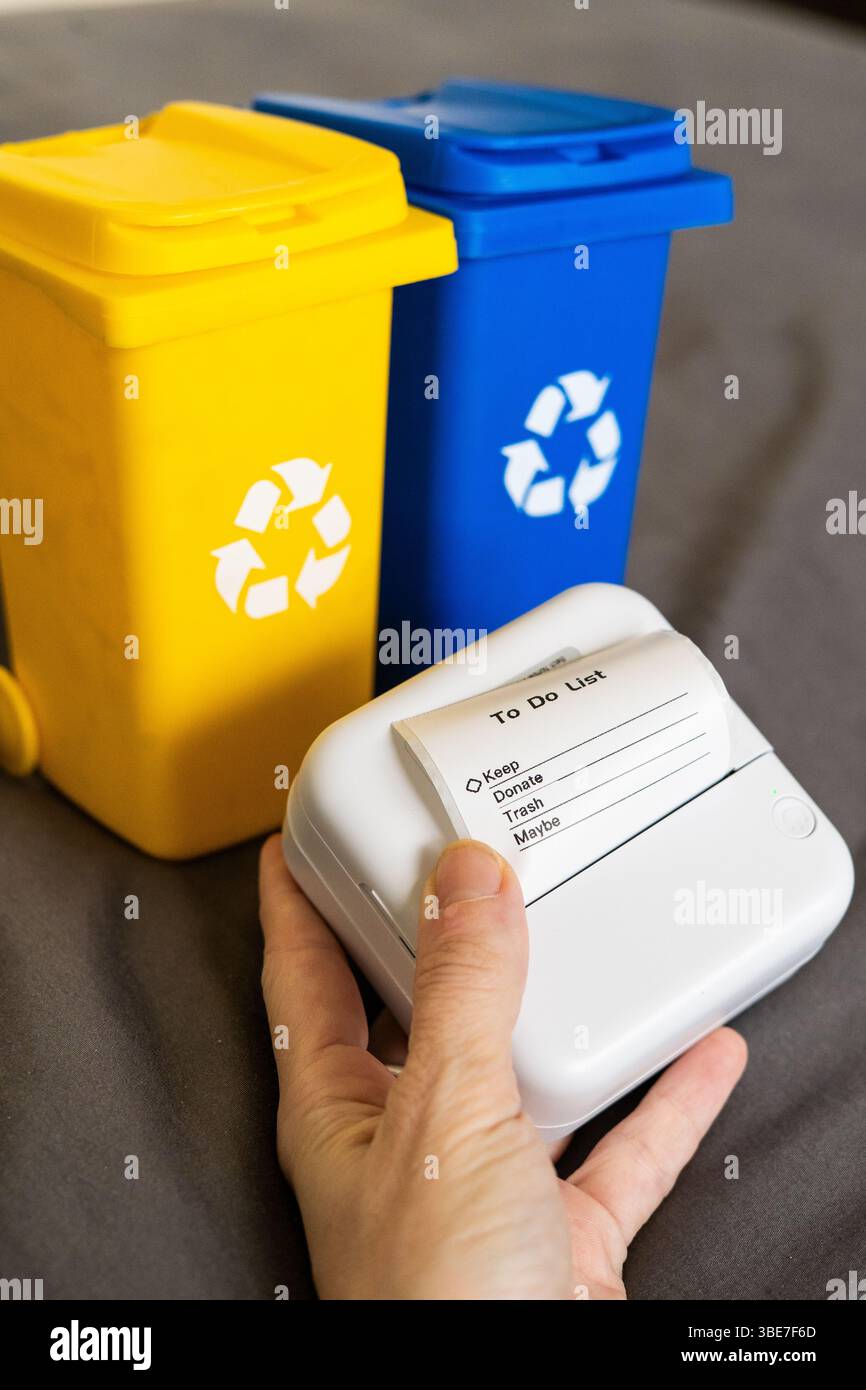 Hand Holding Device with To Do List and Recycling Bins Stock Photo