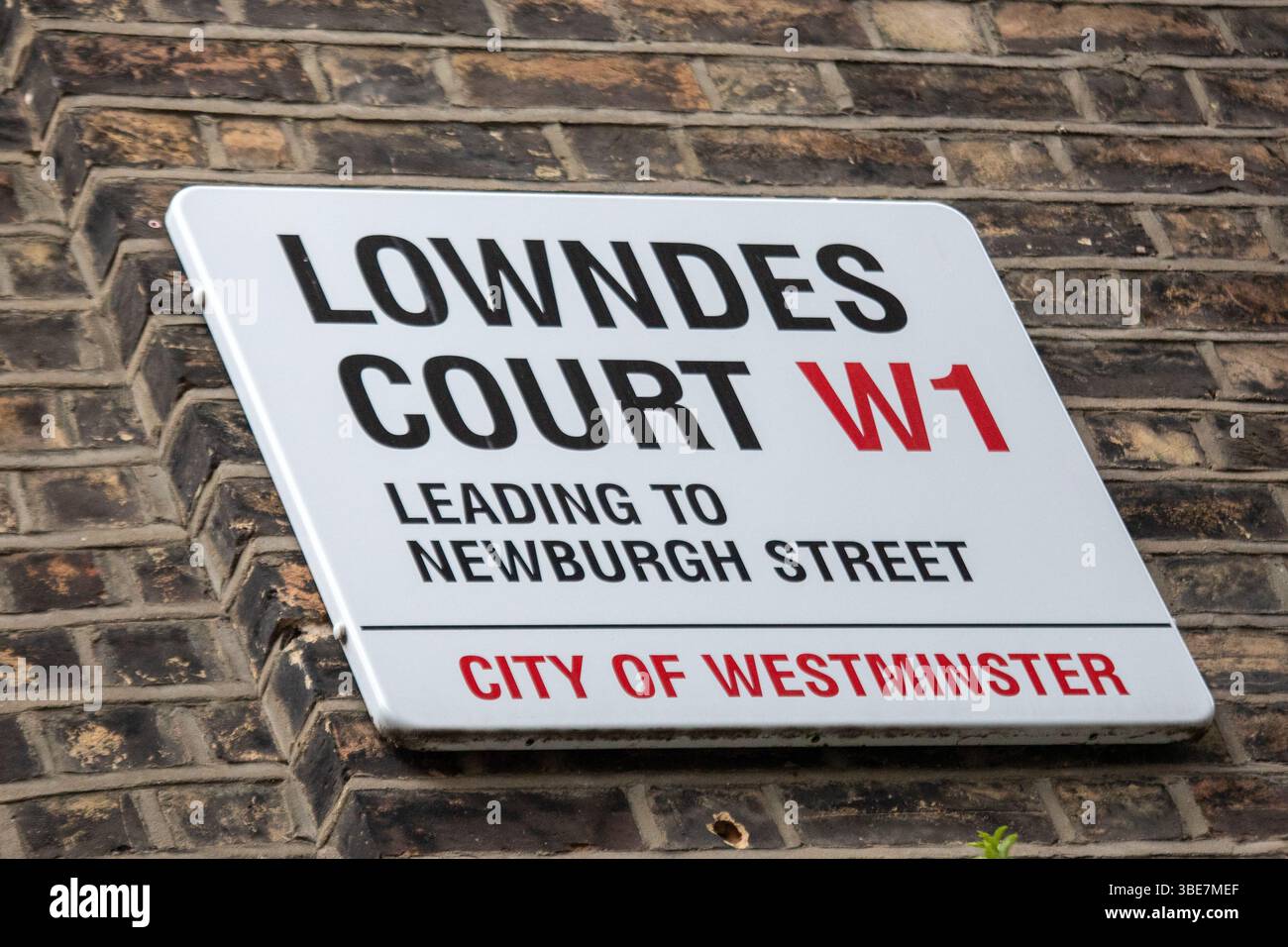 Street sign for Lowndes Court leading to Newburgh Street in Westminster, London. Stock Photo