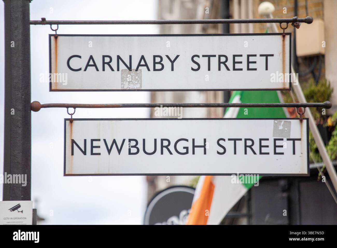 Street signs for Carnaby and Newburgh Streets in Londons vibrant shopping district. The signs are iconic in the citys fashion and cultural hub. Stock Photo