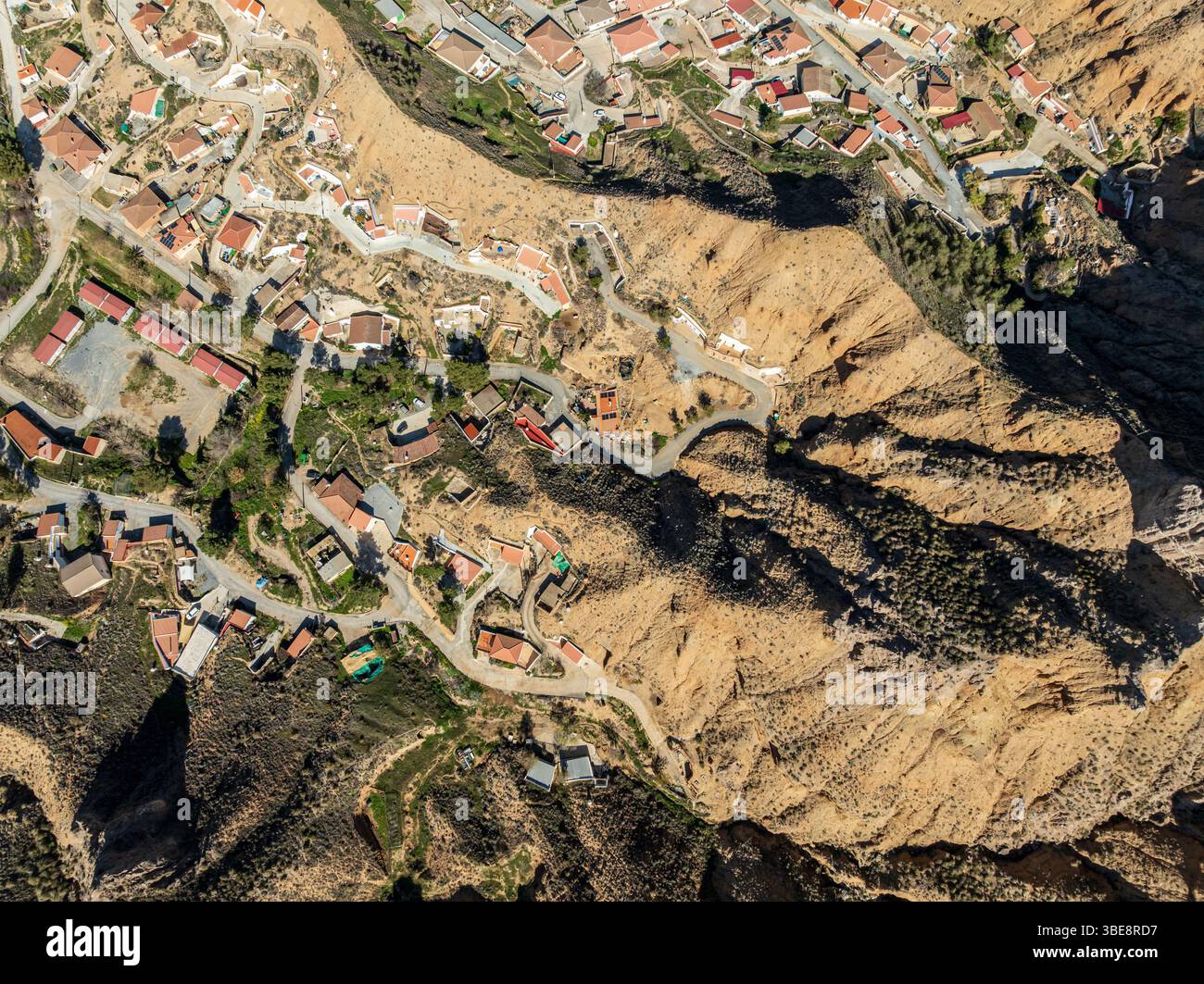 Village Gorafe at the foot of  a deep gorge, aerial view, Gorafe Desert, UNESCO Granada Geopark, Granada province, Andalusia, Spain Stock Photo