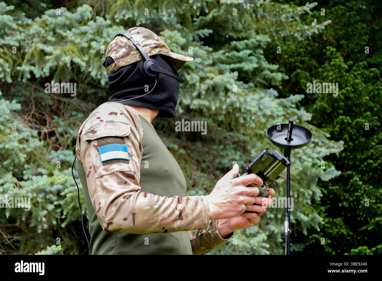 A Ukrainian soldier in camouflage with a drone control panel and ...