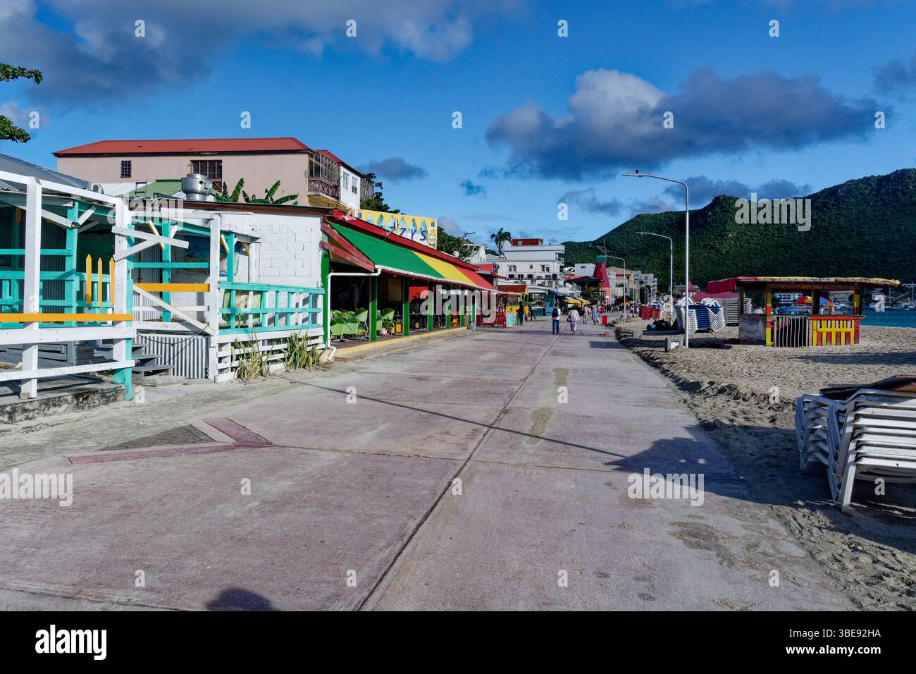 St Maartens beach road with shops, restaurants and people - brightly colored buildings Stock Photo