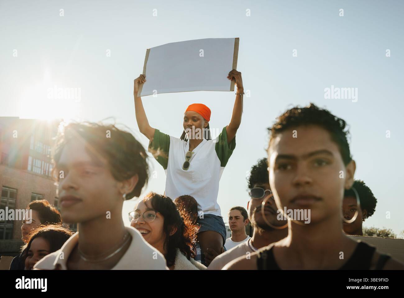 A group of socially active individuals engaged in a peaceful demonstration against discrimination, showcasing advocacy and unity. A young woman holds Stock Photo
