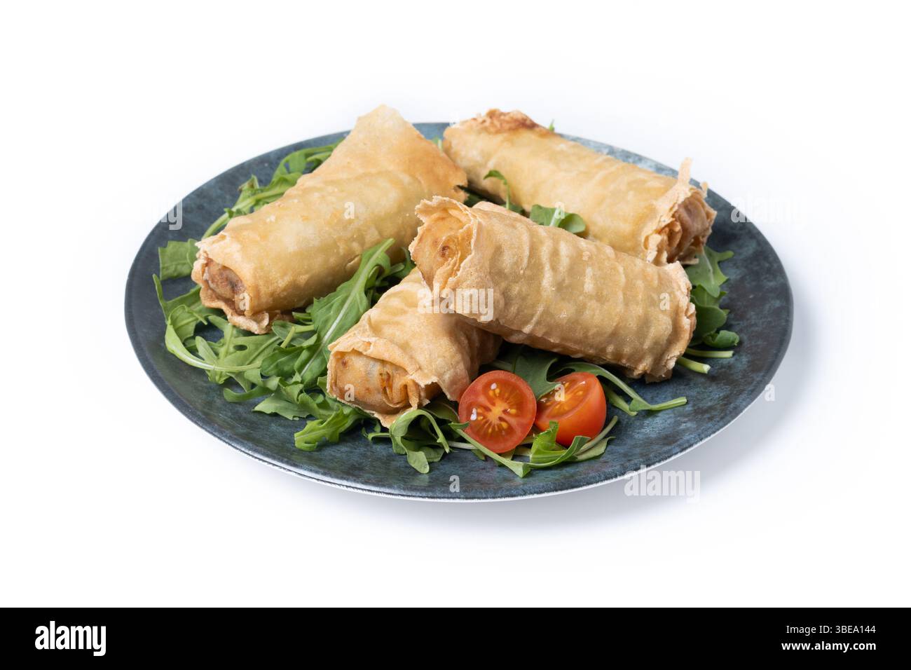 Crispy vegetables spring Rolls on Ceramic Plate isolated on white background Stock Photo