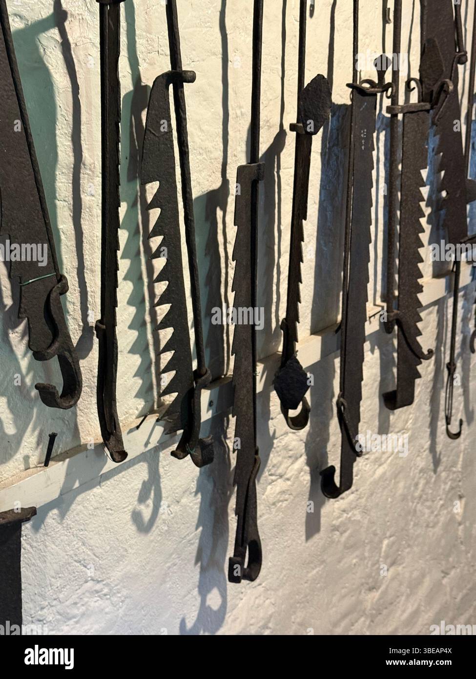 Old fashioned irons with teeth. Called andirons, adjustable, used to lift cooking grates above the heat to prevent burning the meat/food. - Smartphone Captured Stock Image