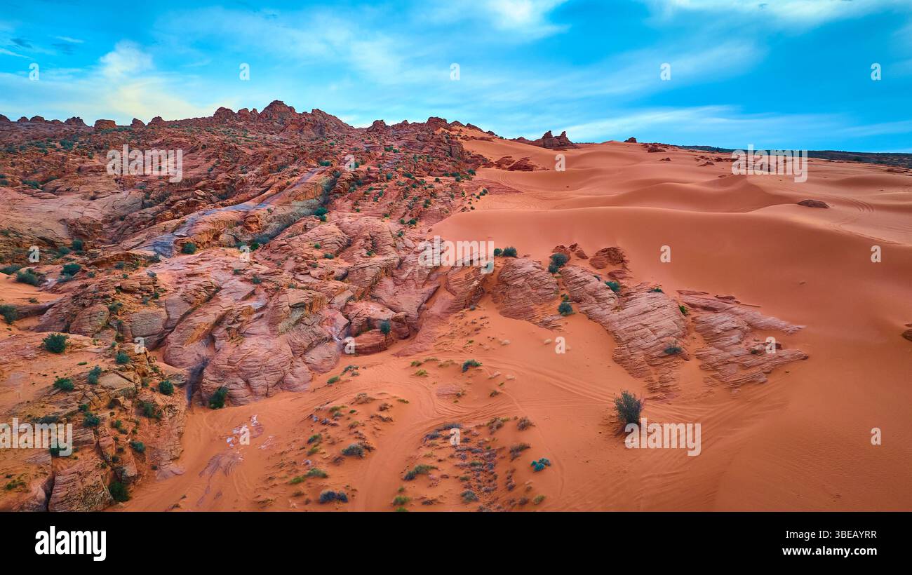 Aerial Red Rock Ridges and Sand Dunes in Motion Over Desert Landscape ...