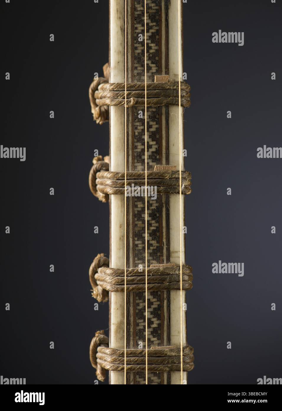 Ancient Asian stringed musical instrument on black background with ...
