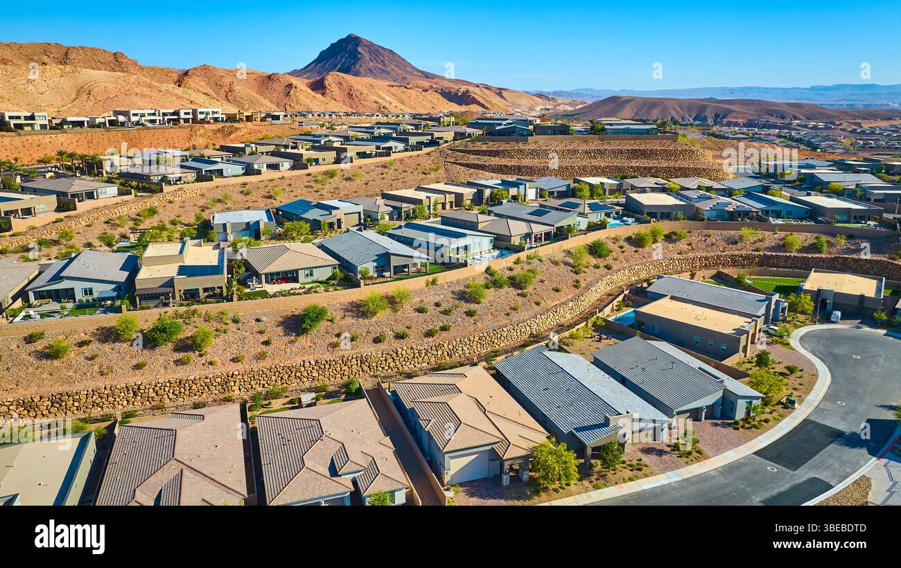 Aerial view of modern new home community in Las Vegas suburbs with desert mountains
