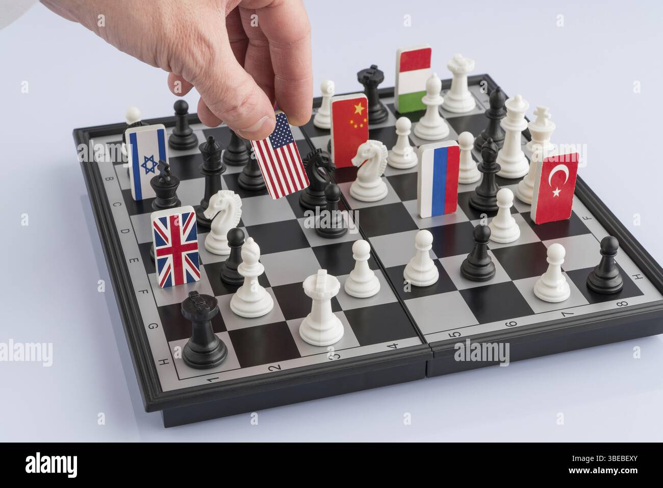 Politician's hand moves a chess piece with a flag. Conceptual photo of ...