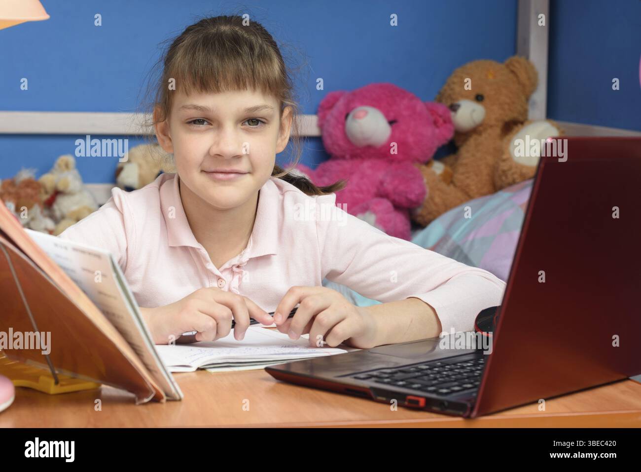 Learning Computer At Home Remote learning at home with a laptop and a textbook Stock Photo - Alamy