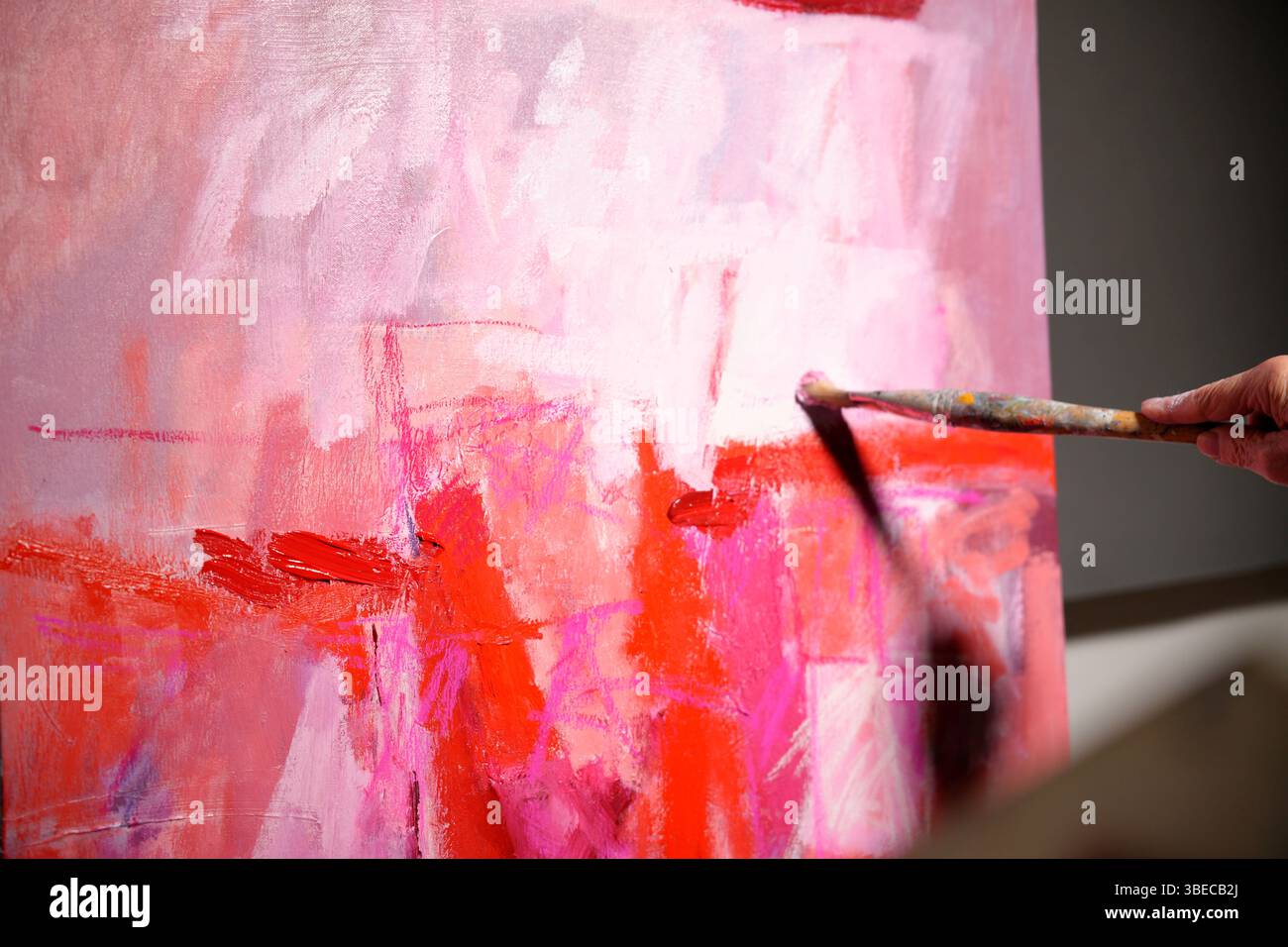 brush painted a picture in pink colors Stock Photo