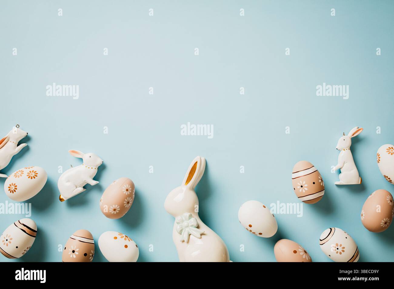 Floral painted Easter eggs in natural colors, decorative rabbits on pastel blue background. Happy Easter card. Stock Photo