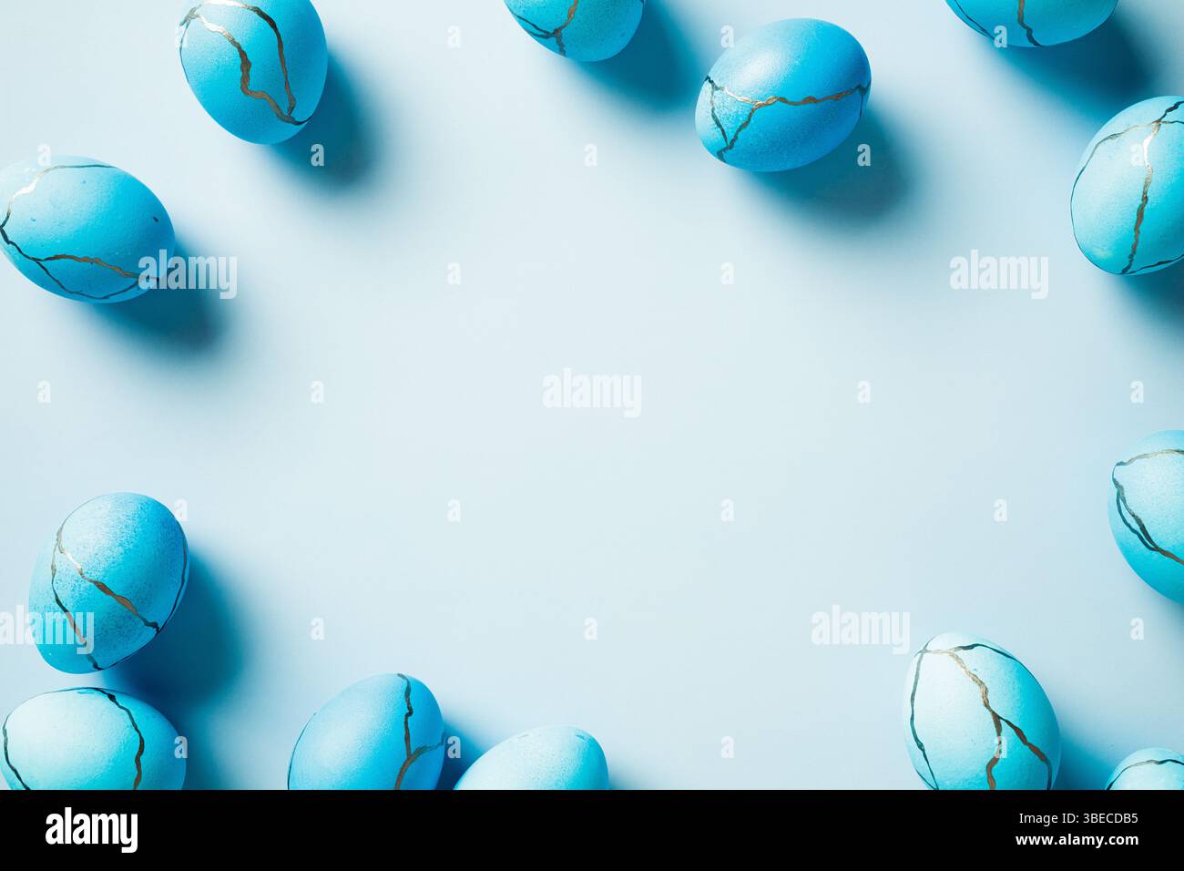 Elegant Easter background with blue Easter eggs on pastel blue table. Minimal style. Stock Photo