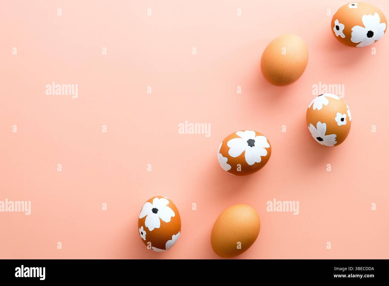 Easter Eggs decorated flowers on pastel pink background. Flat lay, top view. Stock Photo