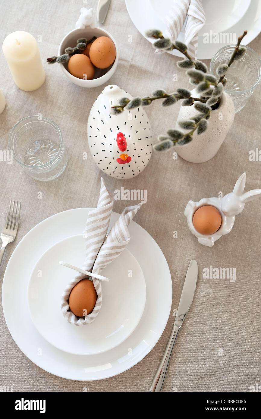 Easter table setting with Easter eggs and willow in vase. Top view. Stock Photo