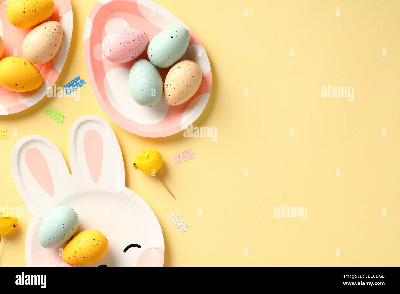 Happy Easter flat lay composition with colorful Easter eggs on cute plates. Stock Photo