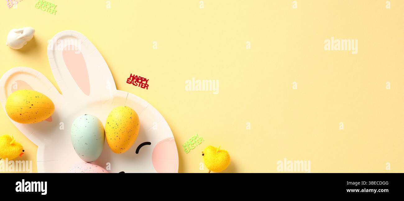 Happy Easter banner with bunny plate and colorful Easter eggs on yellow background. Stock Photo