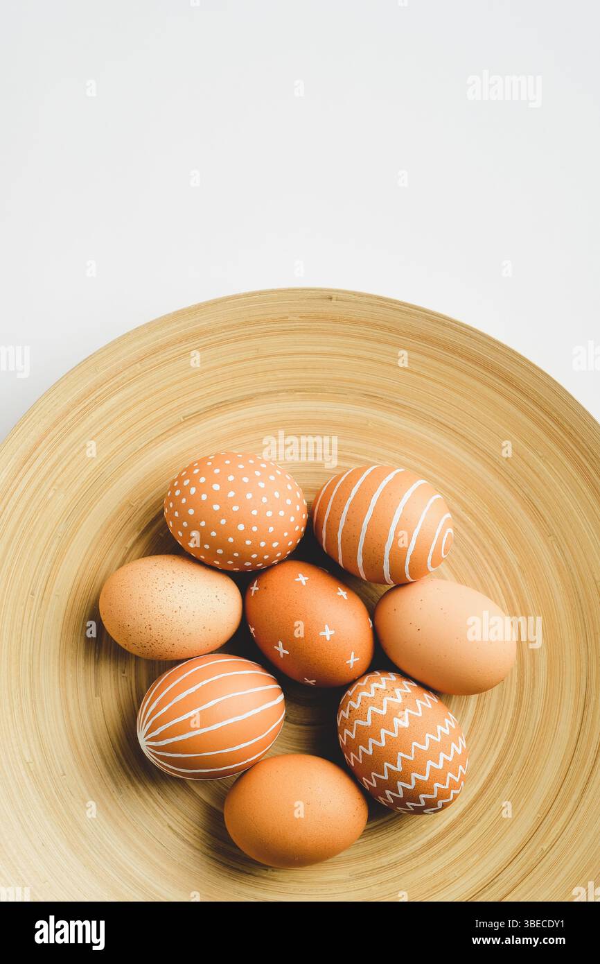 Simple Easter eggs on elegant plate on white background. Happy Easter concept. Stock Photo