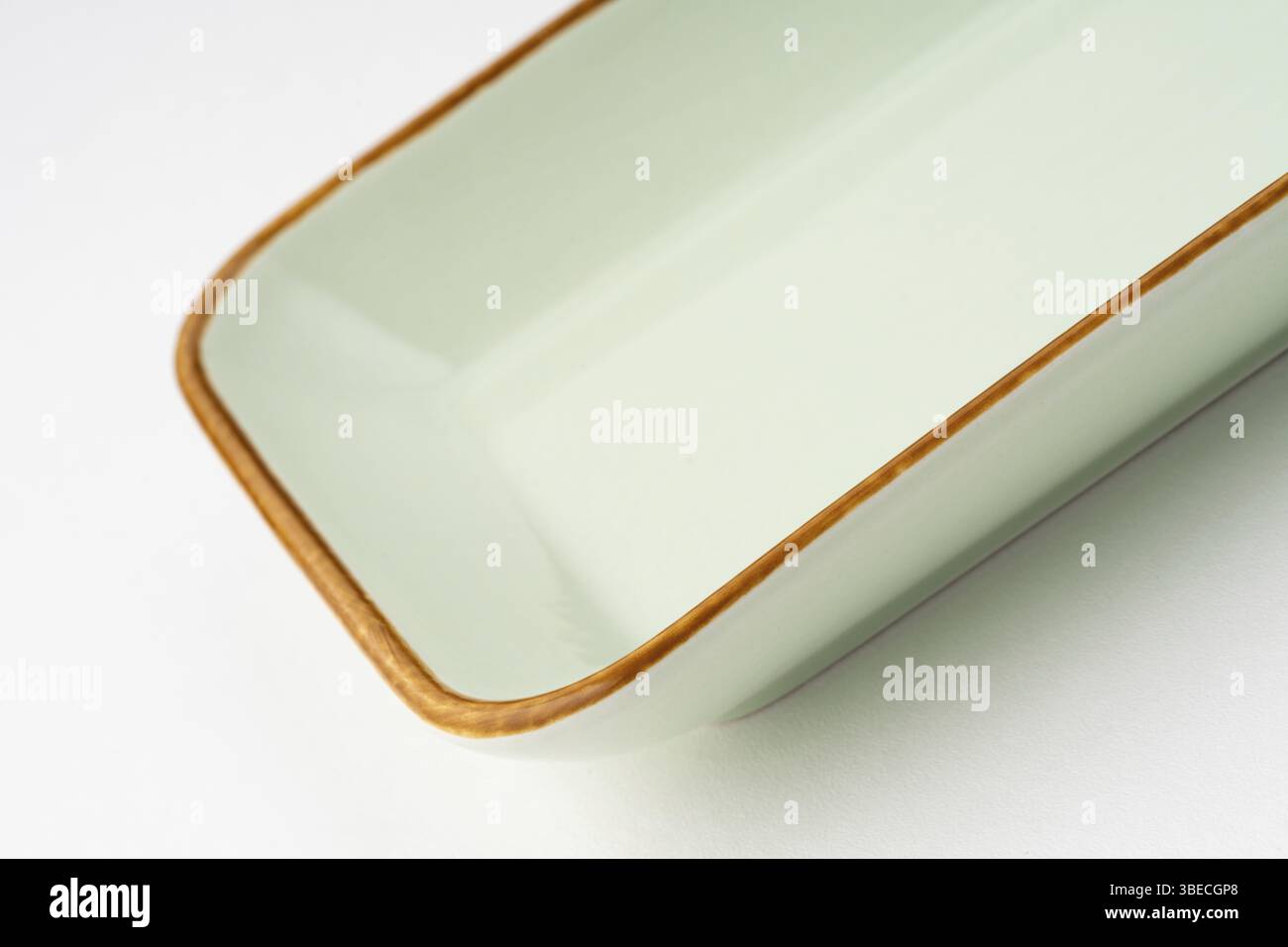 A one ceramic green rectangular plate isolated on white background Stock Photo