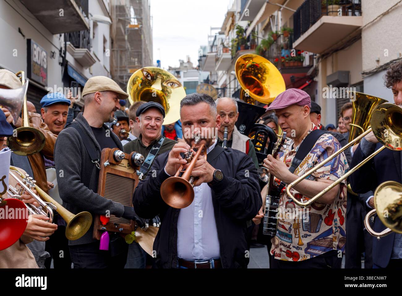 Spain, Sitges, Sitges Jazz Festival, musicians playing instruments in the a street parade. Stock Photo