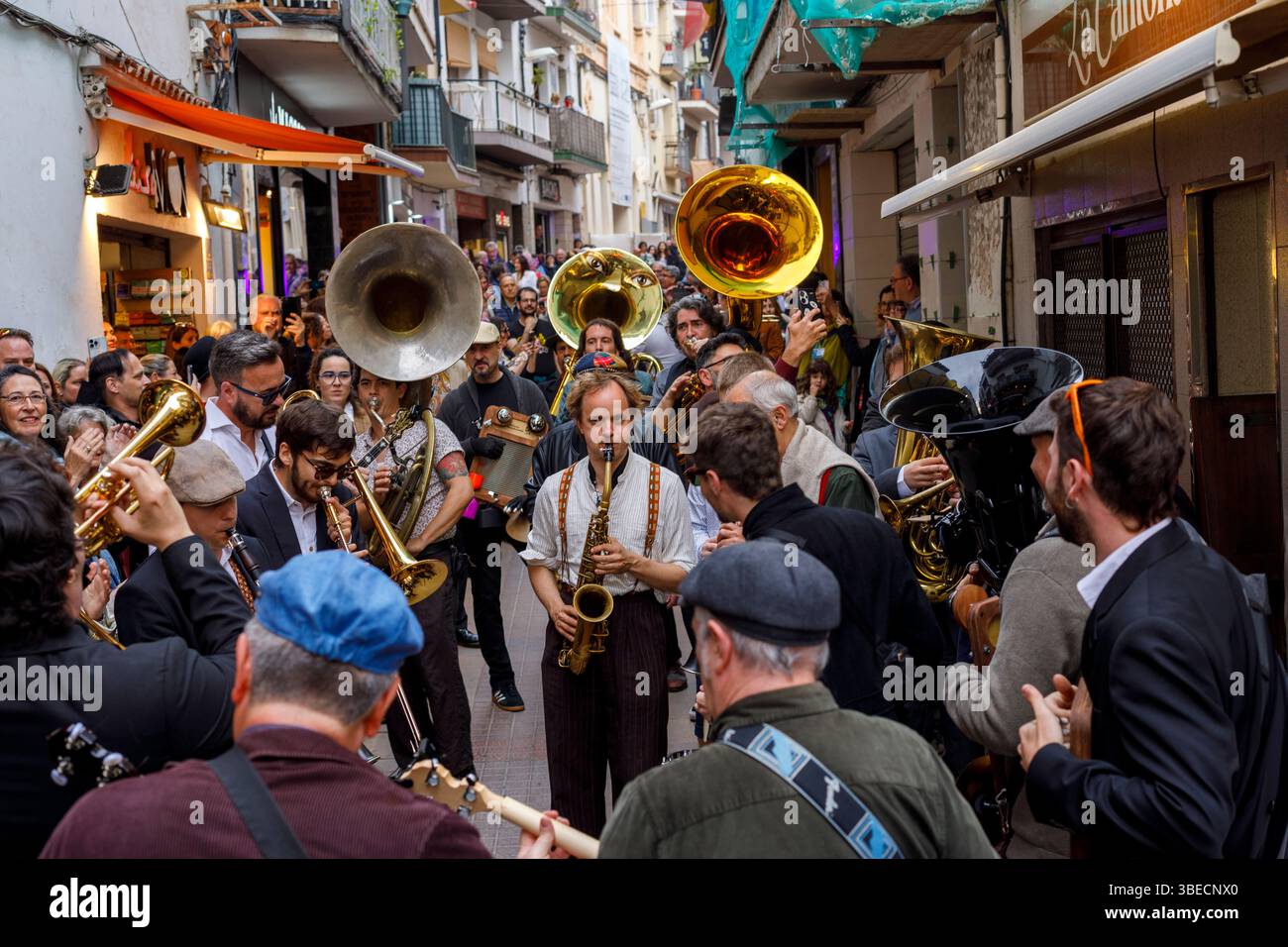 Spain, Sitges, Sitges Jazz Festival, musicians playing instruments in the a street parade. Stock Photo