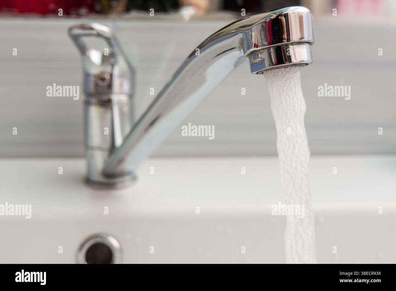 Water pours more pressure from the mixer in the bathroom Stock Photo