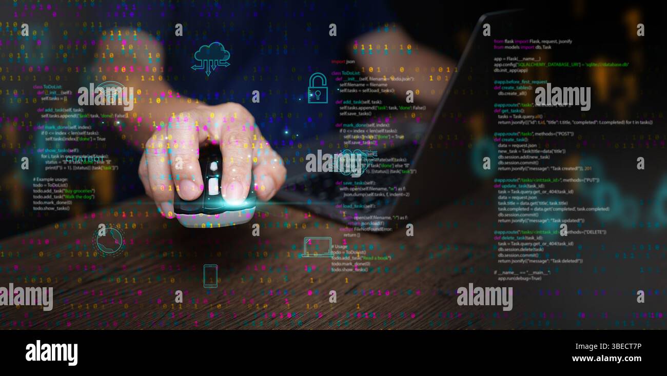 Digital technology and cloud computing: concept. A man using a mouse and laptop to create, store, process, and communicate information as data represe Stock Photo