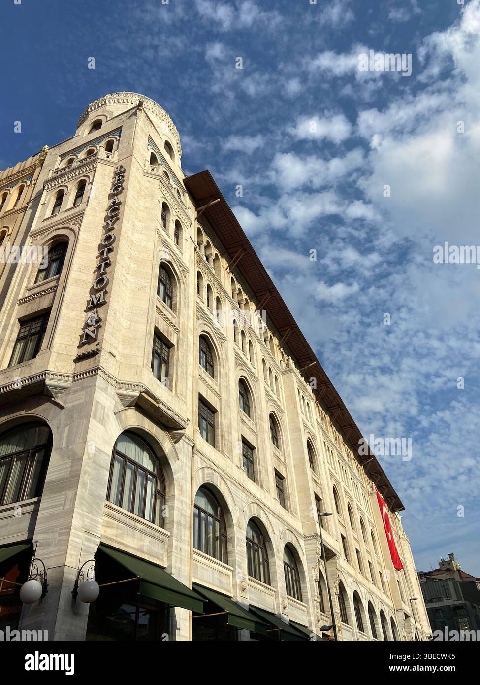 Historical architecture building with arched windows under a dramatic cloudy sky in Istanbul. - Smartphone Captured Stock Image