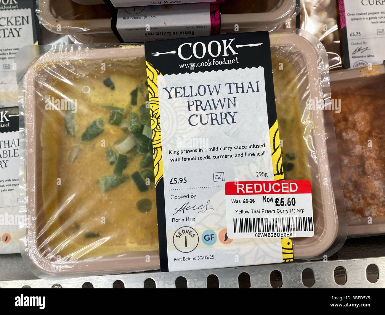 Yellow Thai Prawn Curry Individual frozen Ready Meals for sale at reduced price in a shop freezer cabinet, UK - Smartphone Captured Stock Image